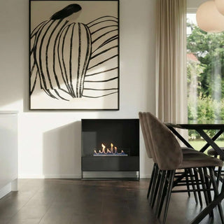 Modern living room with a fireplace, abstract wall art, and a dining table.