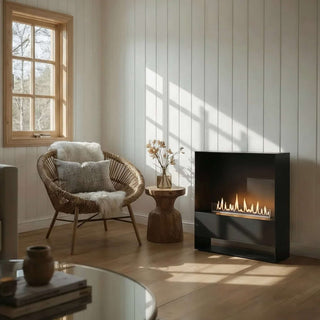 Modern living room with a fireplace, wicker chair, and wooden table.