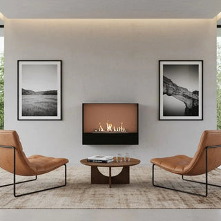 Modern living room with a fireplace, two chairs, and large windows.
