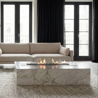 Modern living room with a sectional sofa, chair, and fire pit table.