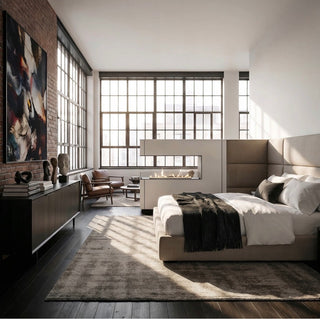 Modern bedroom with large windows, a fireplace, and a bed.