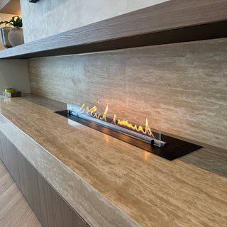 Modern fireplace with wooden mantle and decorative elements in a room.