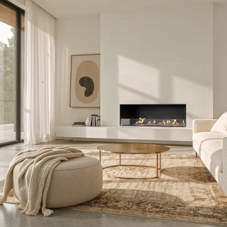 Modern living room with a fireplace, sofa, and large windows.