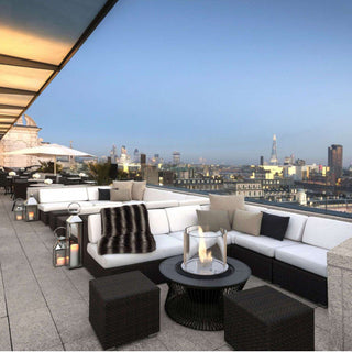Modern outdoor lounge area with city skyline view