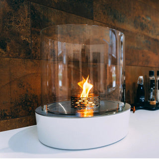 Modern indoor fireplace with glass cover on a kitchen counter